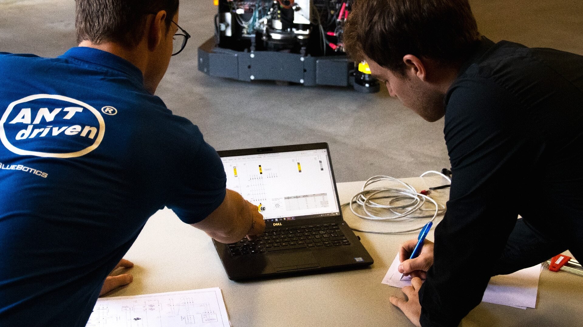 A BlueBotics engineer working with a customer