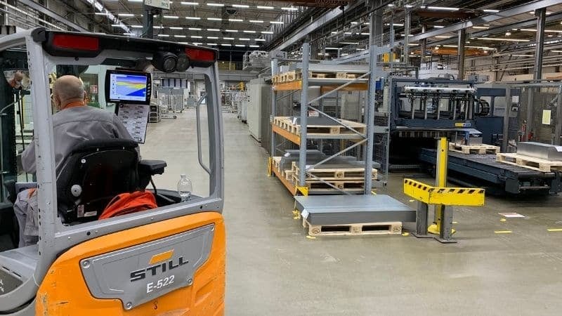 A manual forklift at work in a warehouse, following a forklift tracking map.