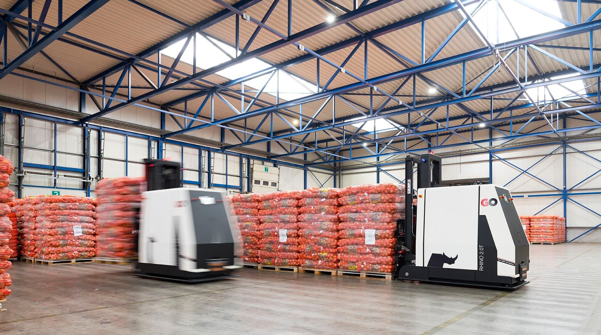 Two Rhino AGVs at work in a food processing facility